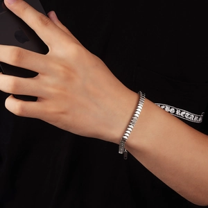 Close-up of titanium steel fish scale link bracelet with industrial chic design for men