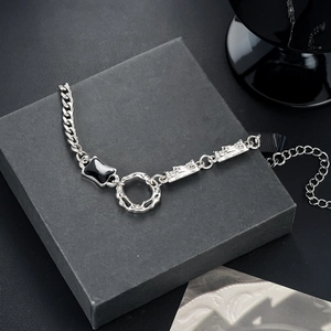 Macro detail of silver titanium steel bracelet with black geometric inlay and Cuban links