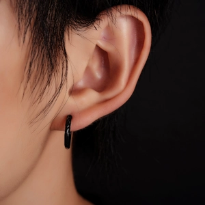 Minimalist black hoop earring with textured metallic finish for men and women