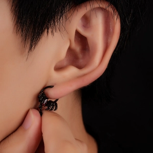 Gothic black scorpion ear wrap earring with a vibrant red zircon stone on model