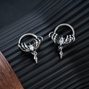 Detailed view of silver gothic claw earrings with marquise stone and cone pendants