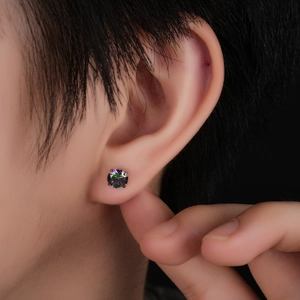 Macro view of rainbow crystal stud earrings with six-prong titanium setting on earlobe
