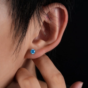 F136 titanium earring with round brilliant cut sky blue zircon in a four-prong setting