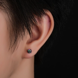 Macro shot of titanium labret earring with rainbow zircon in a four-prong setting