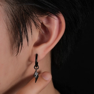 Close-up of black lightning bolt hoop earring with micro-paved rhinestones on ear