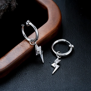 Macro view of crystal paved lightning bolt pendant earrings in silver titanium steel