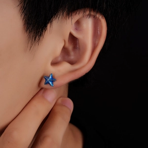Blue starfish stud earring with silver grain accents on a real model ear close-up