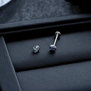 Macro shot of titanium rainbow crystal piercing studs with four-prong setting and flat back