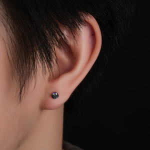 Close-up of rainbow zirconia titanium stud earring with four-prong setting on ear lobe