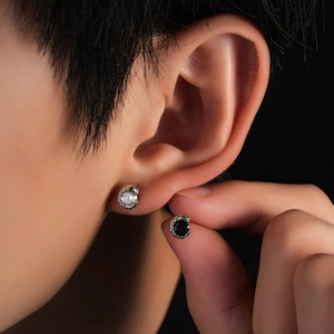 Serpent stud earrings with black and white diamonds and green gemstone eyes for men