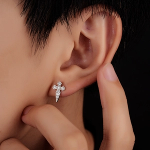 Punk style silver cross sword stud earring with zircon stones on a model ear