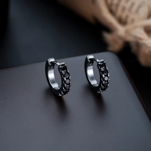 Macro shot of black huggie hoop earrings with micro-pave black cubic zirconia stones