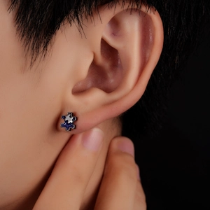 Minimalist irregular puzzle stud earring in blue and silver enamel finish on model
