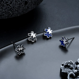 Puzzle shaped stud earrings in black and blue enamel finish for men and women