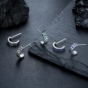 Minimalist C-shaped geometric hoop earrings in various metallic finishes and patterns
