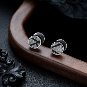 Detailed view of unisex stainless steel stud earrings with dark glitter and geometric patterns