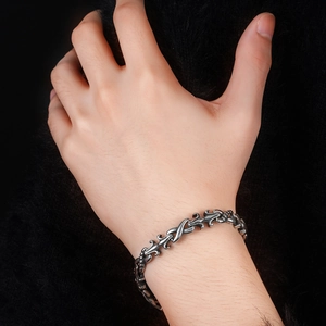 Macro shot of retro titanium steel bracelet with baroque textures on a male wrist