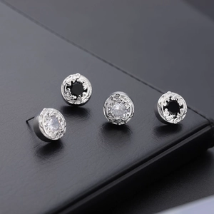 Detailed macro view of vintage round earrings with intricate filigree and zircon stones
