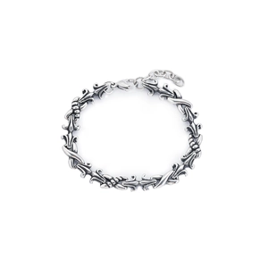 Retro gothic silver titanium steel bracelet with intricate hollow carved links on white background