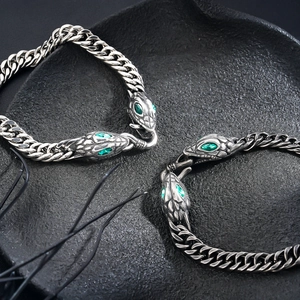 Vintage titanium steel Cuban link bracelet featuring snake head with green gem eyes