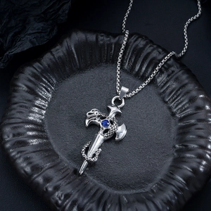 Close-up of gothic sword pendant with carved snake and deep blue gemstone detail