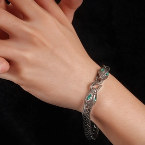 Vintage titanium steel snake bracelet with green eyes and double head design on wrist