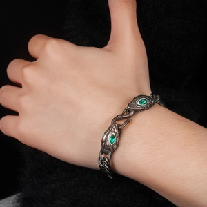 Gothic titanium steel snake head bracelet with emerald green eyes and scale texture