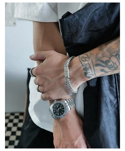 Detail of silver double-layer titanium bracelet with rectangular metal clasp on wrist