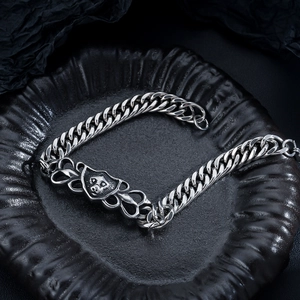 Detail of vintage silver lion head bracelet with heavy punk style cuban chain link