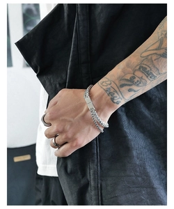 Close-up of minimalist double-layered titanium steel bracelet with mirror metal plate
