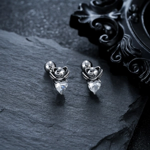 Titanium steel cat earrings with heart zirconia on dark stone background