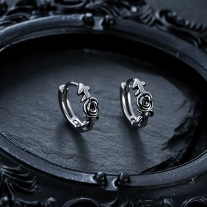 Gothic rose and leaf hoop earrings in vintage silver steel on black stone display