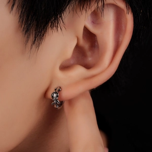 Three-dimensional silver rose earring with a central zircon stud on male model ear