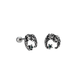 Retro titanium steel rose earrings with green zircon and star charm on white background