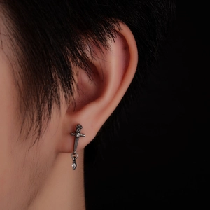 Gothic silver sword stud earring with sparkling crystals on minimalist black background