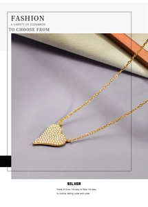 Detailed close-up of S925 sterling silver gold heart pendant with sparkling pavé zircons