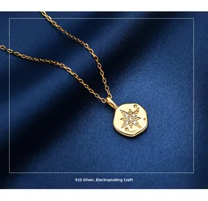 Detailed macro view of S925 sterling silver gold plated star coin pendant with zircons