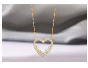 Macro view of micro-set heart pendant in S925 silver with sparkling zircon details