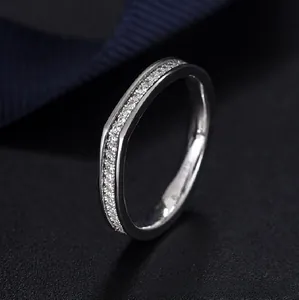 Close-up of a curved 925 sterling silver ring with delicate pave diamond setting