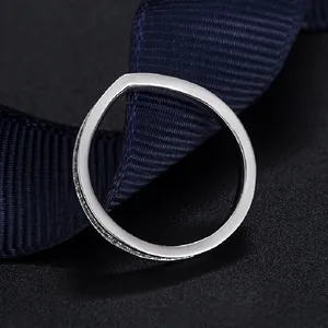 Macro view of 925 sterling silver V-shaped ring with pave zircons and polished finish