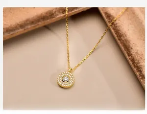 Macro shot of S925 silver gold-plated necklace with sparkling round pave pendant