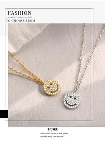 Close-up of gold and silver smiley face necklaces with pavé cubic zirconia inlay