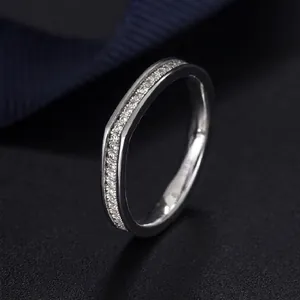 925 sterling silver V-shaped ring with pavé diamonds on a black textured background