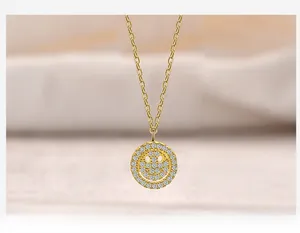 Macro view of gold-plated sterling silver smiley face pendant with micro-pave zircons