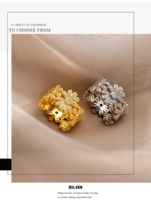 Detail view of two S925 sterling silver daisy rings with micro-pave white zircon petals