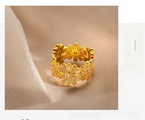 Macro shot of S925 silver daisy rings with zircons on elegant champagne satin