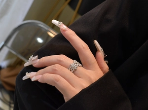 Detail of S925 sterling silver daisy ring with micro-pave crystals on hand