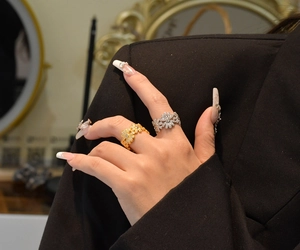 Detail of S925 silver daisy rings in gold and silver finish with pavé set crystals