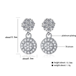 Detailed view of silver drop earrings with 7A zircon pavé and platinum plating specs