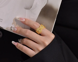 Detail of S925 silver daisy ring with micro-set crystals worn on finger in luxury setting